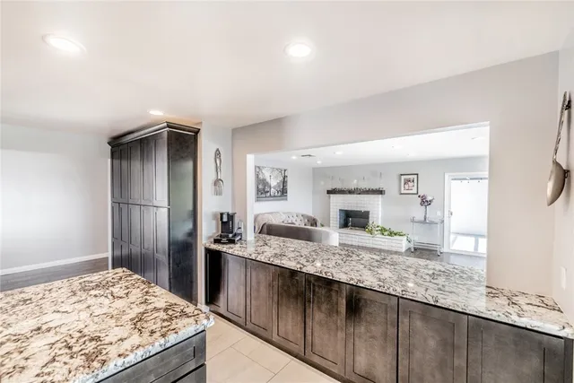 a view of living room kitchen with furniture and wooden floor