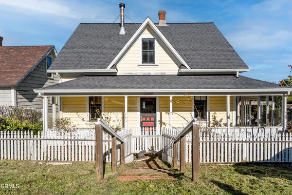 a front view of a house with wooden deck