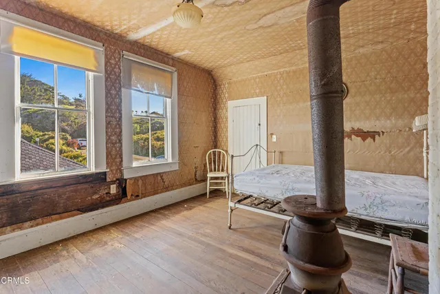 a living room with furniture window and wooden floor