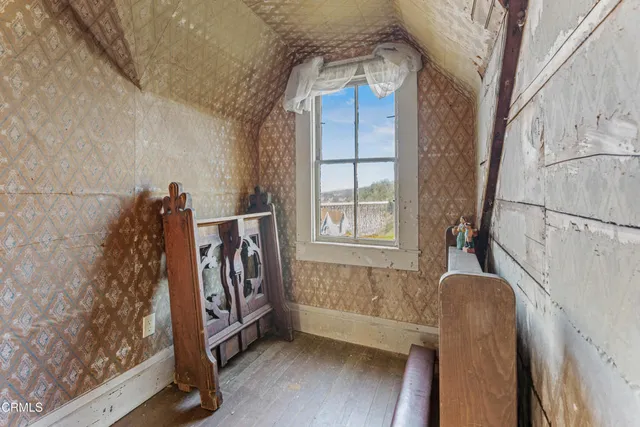 a view of a porch with a table and chairs