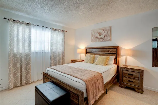 a bedroom with a bed and a television