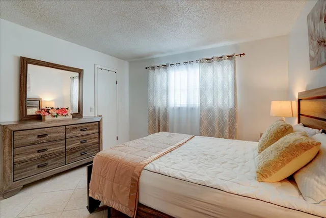 a bedroom with a bed and a dresser