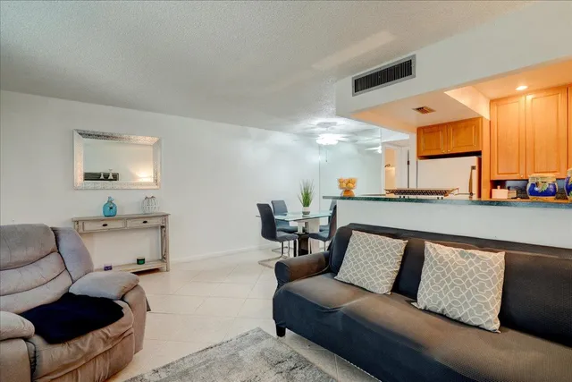 a living room with furniture and a lamp