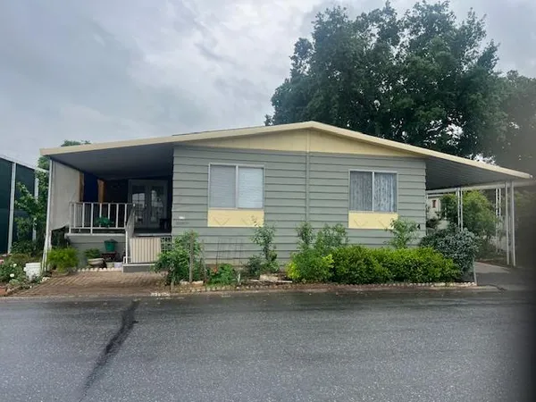 a front view of a house with a yard and a garage