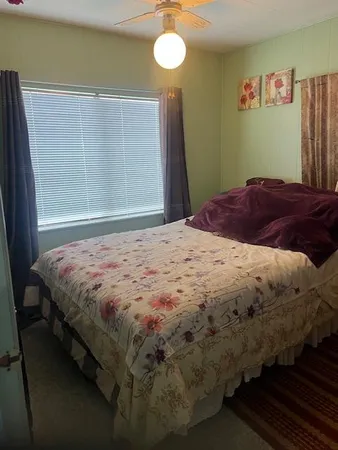 a bedroom with a bed and a window