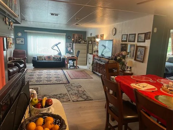 a living room with patio furniture and a flat screen tv