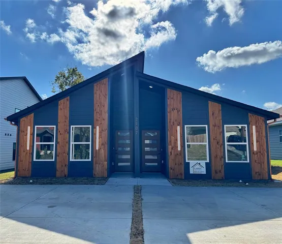 a view of a house with entryway and wooden walls