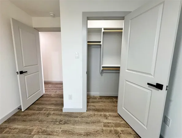 a kitchen with a stove and a wooden floor
