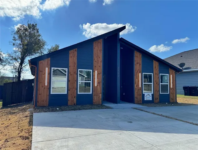 a view of a house with a large space and a yard