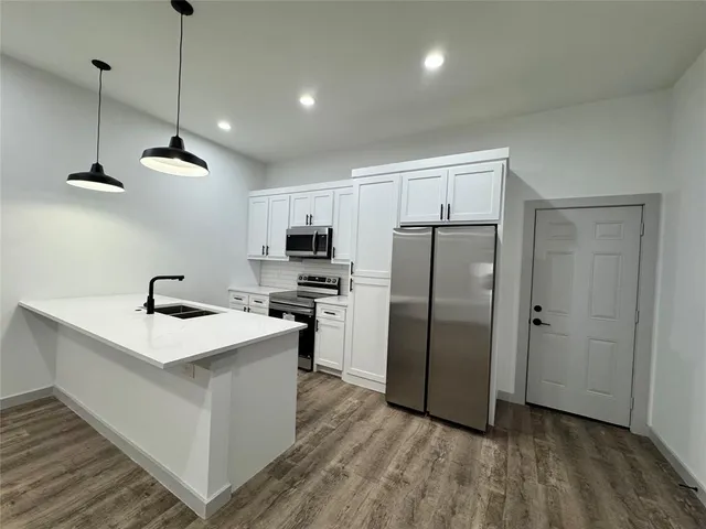 a kitchen with stainless steel appliances a refrigerator sink and stove