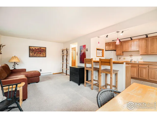 a living room with stainless steel appliances kitchen island furniture and a window