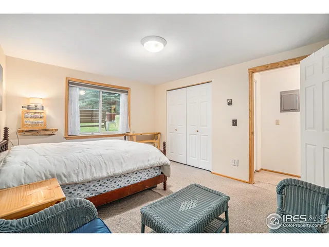 a bedroom with two beds and a desk