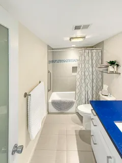 a spacious bathroom with a tub toilet and a shower