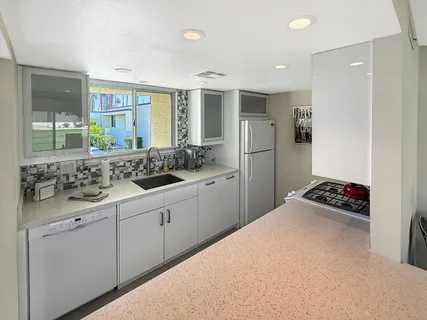 a kitchen with a sink and a stove top oven