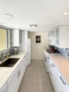 a kitchen with a sink and a refrigerator
