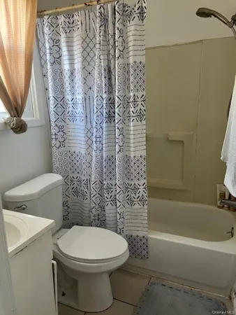 a bathroom with a toilet and shower