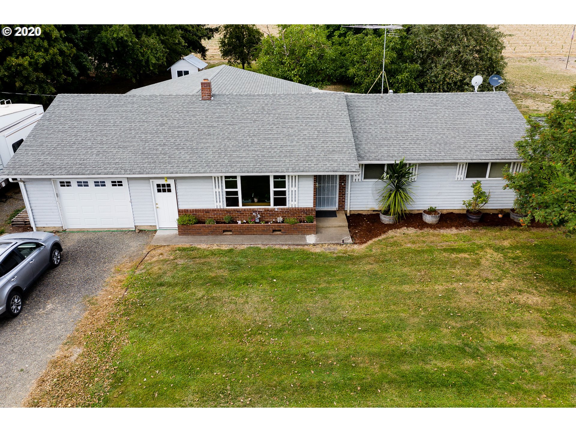 a aerial view of a house with table and chairs