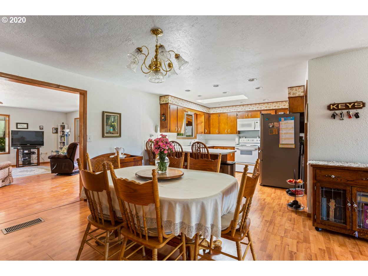 12655 Oak Road Northwest Salem, OR 97304 - Photo 7 of 24 a view of a dining room with furniture and wooden floor