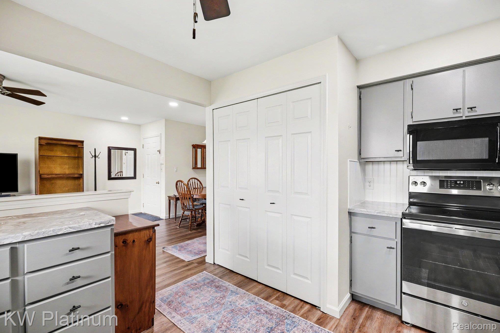 1700 River Road, Unit 6 Marysville, MI 48040 - Photo 11 of 32 Kitchen area featuring stainless steel appliances, light gray cabinetry, and a white beadboard backsplash