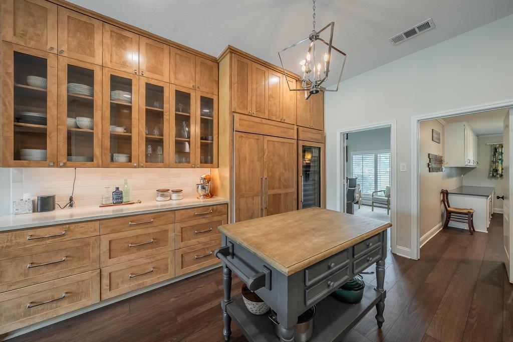 115 Pheasant Run Road Argyle, TX 76226 - Photo 12 of 40 a kitchen with a table chairs refrigerator and cabinets