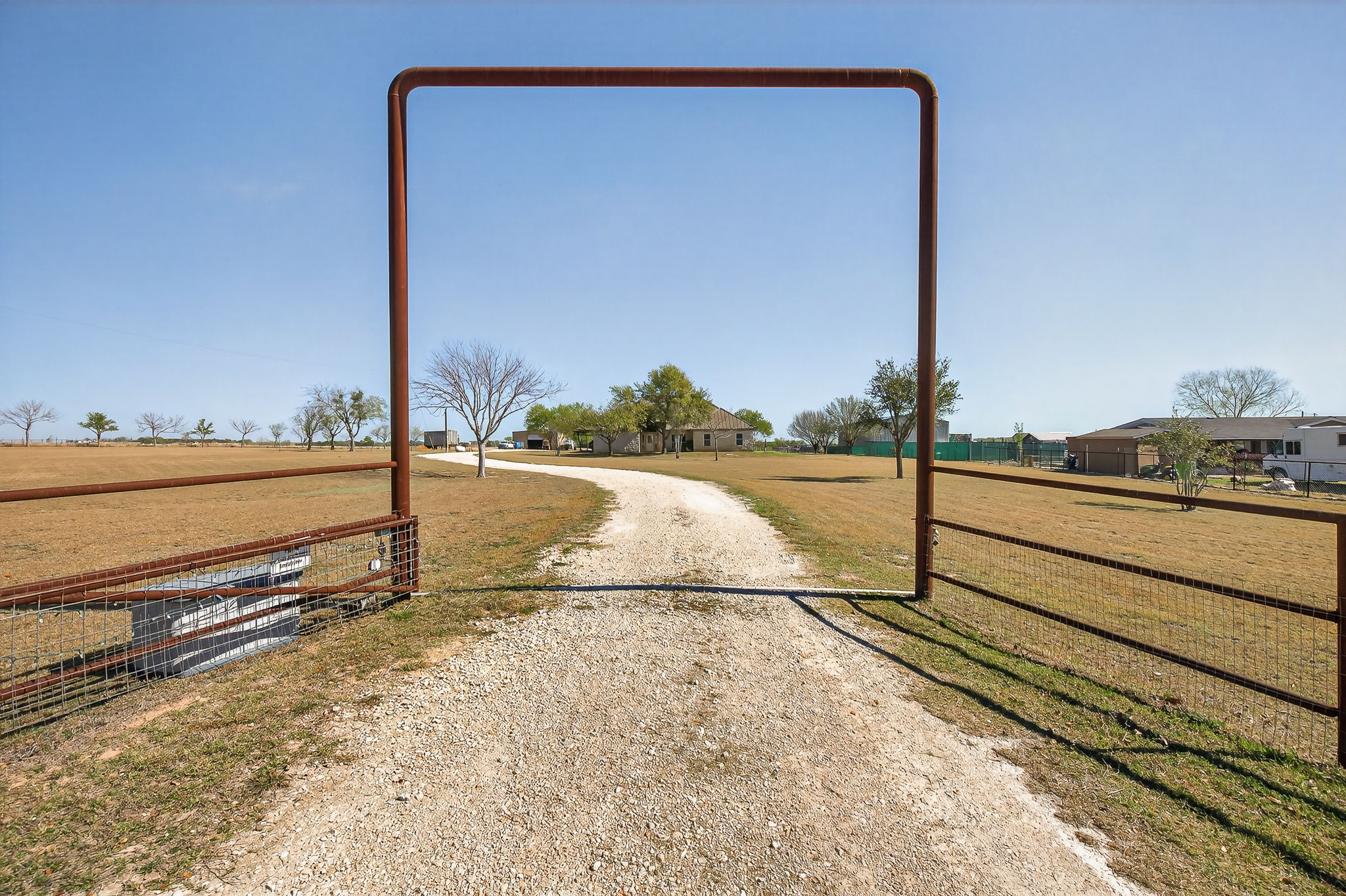 13639 Abrahamson Road Elgin, TX 78621 - Photo 4 of 30 With a private gate, fully fenced, it says Texas