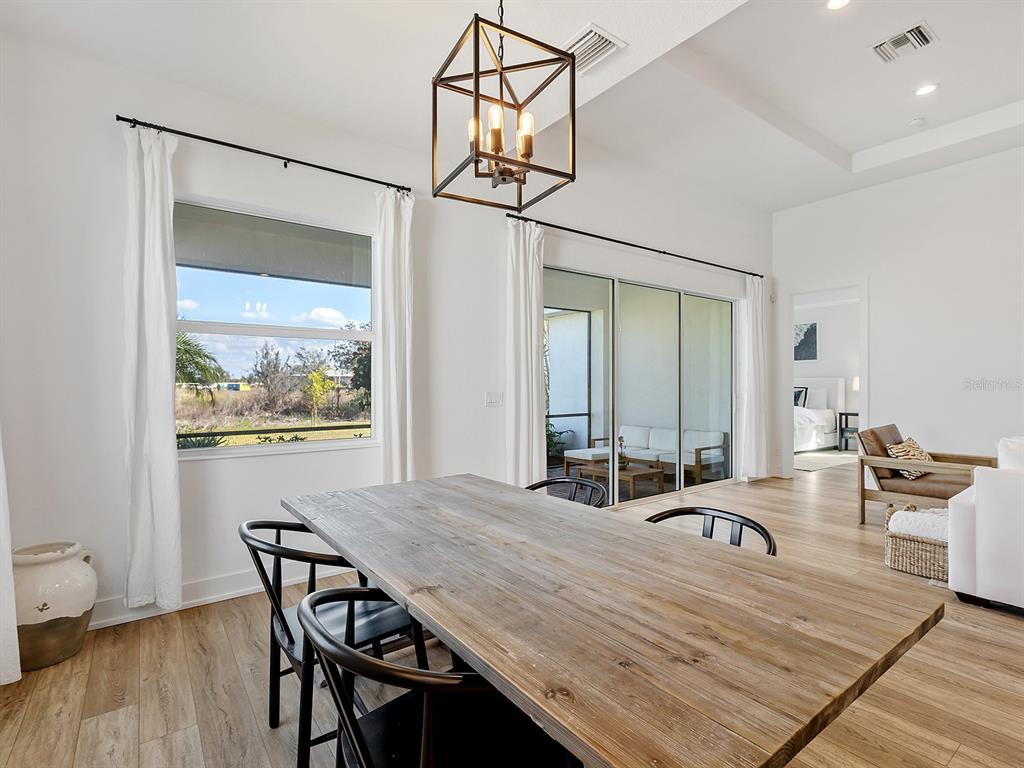 7857 Redonda Loop Lakewood Ranch, FL 34202 - Photo 15 of 51 a dining room with a table and chairs
