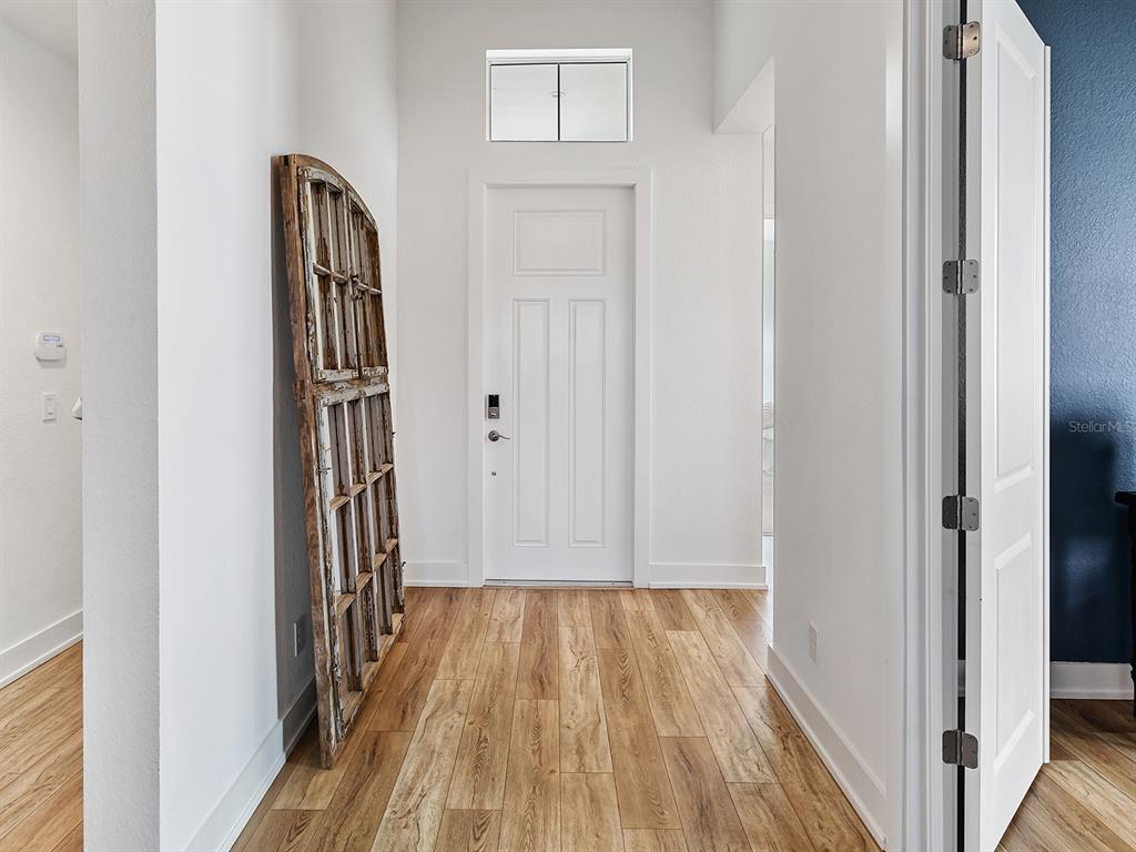 7857 Redonda Loop Lakewood Ranch, FL 34202 - Photo 2 of 51 a view of front door with wooden floor