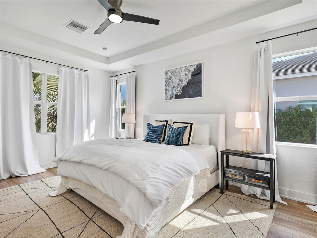 7857 Redonda Loop Lakewood Ranch, FL 34202 - Photo 21 of 51 a bedroom with a large bed and a window