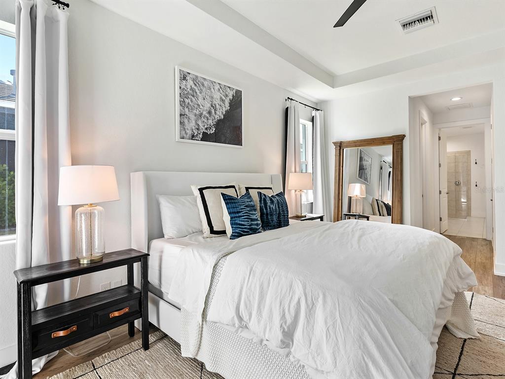 7857 Redonda Loop Lakewood Ranch, FL 34202 - Photo 23 of 51 a bedroom with a bed and a painting on the wall