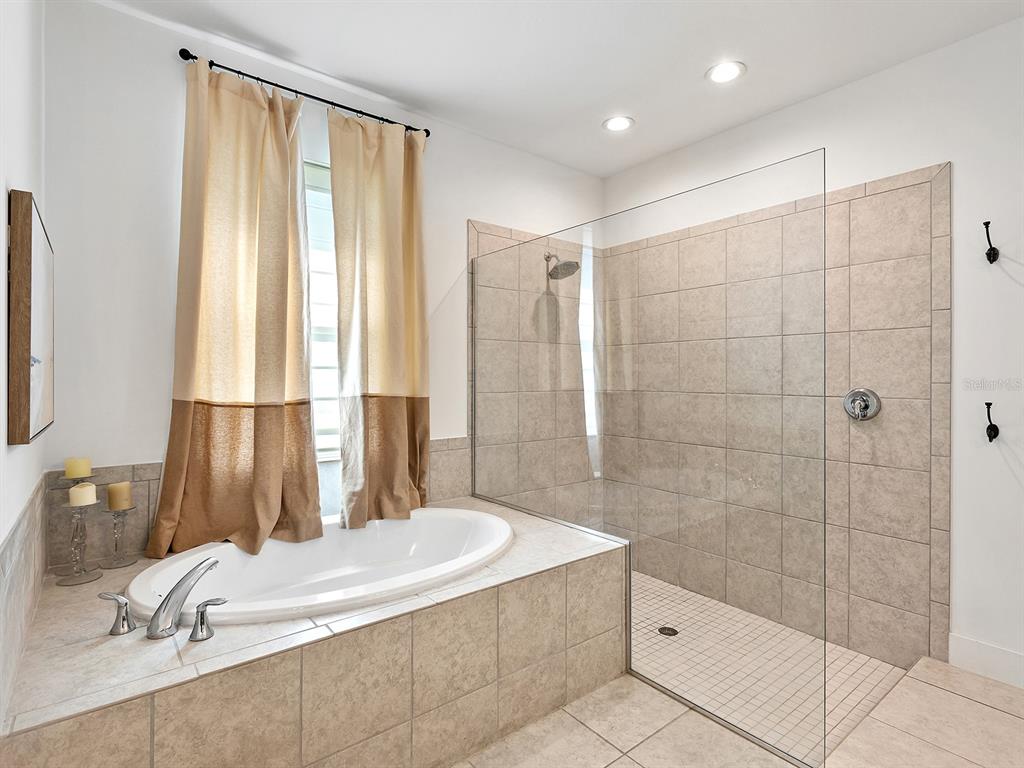 7857 Redonda Loop Lakewood Ranch, FL 34202 - Photo 25 of 51 a bathroom with a granite countertop sink a toilet and shower