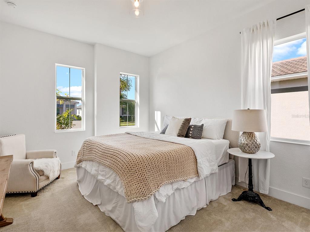 7857 Redonda Loop Lakewood Ranch, FL 34202 - Photo 26 of 51 a bedroom with bed and window