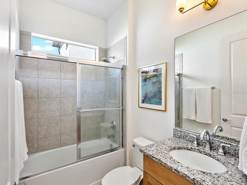 7857 Redonda Loop Lakewood Ranch, FL 34202 - Photo 27 of 51 a bathroom with a granite countertop sink toilet and shower