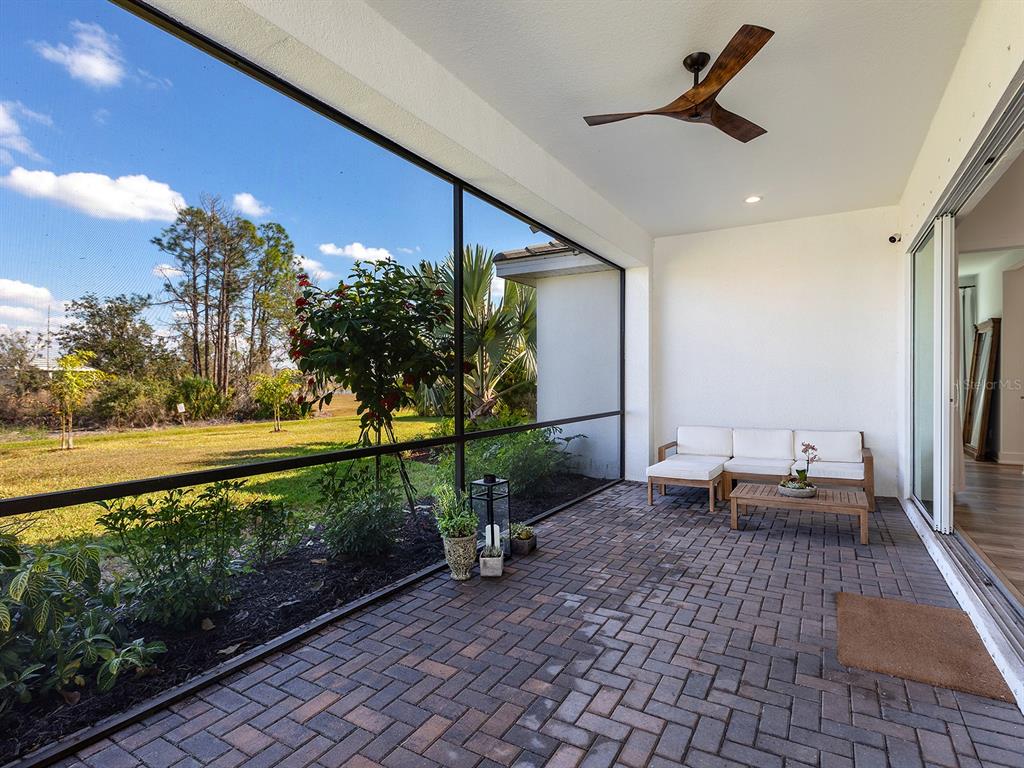 7857 Redonda Loop Lakewood Ranch, FL 34202 - Photo 30 of 51 a living room with couch and a garden