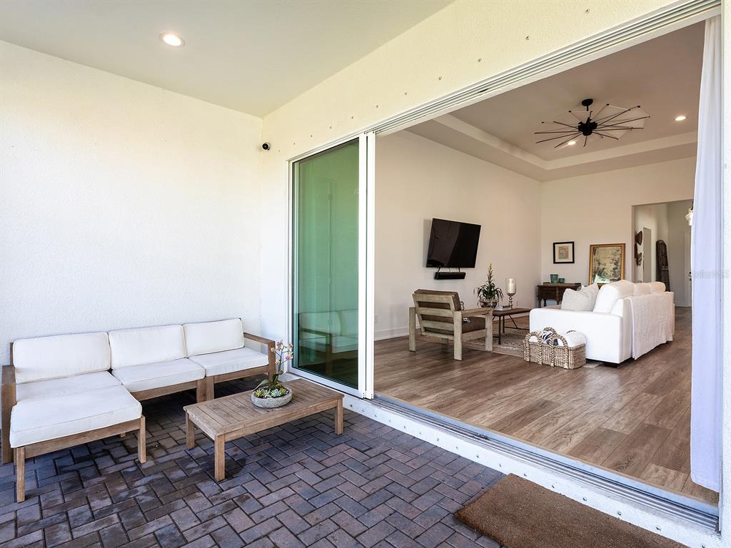 7857 Redonda Loop Lakewood Ranch, FL 34202 - Photo 31 of 51 a living room with furniture and a flat screen tv
