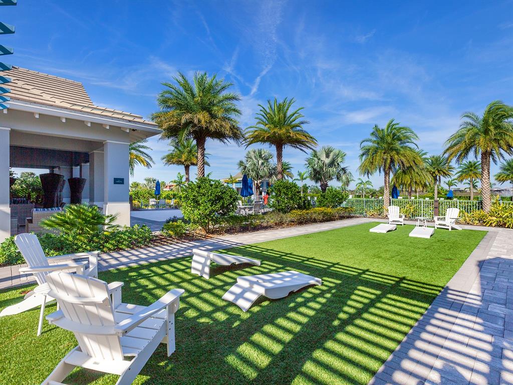 7857 Redonda Loop Lakewood Ranch, FL 34202 - Photo 49 of 51 a view of a backyard with potted plants and palm trees