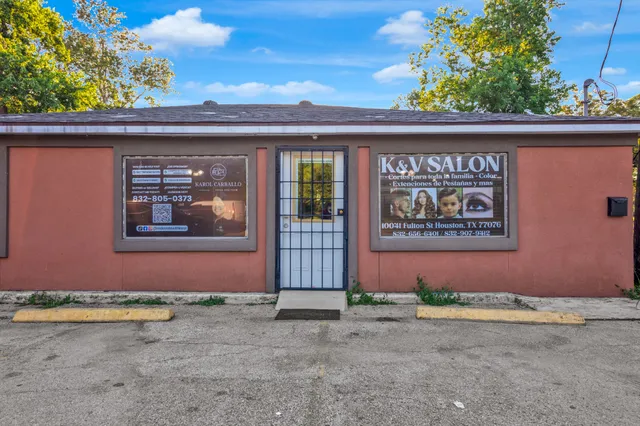 a bathroom with a sink a toilet and a window
