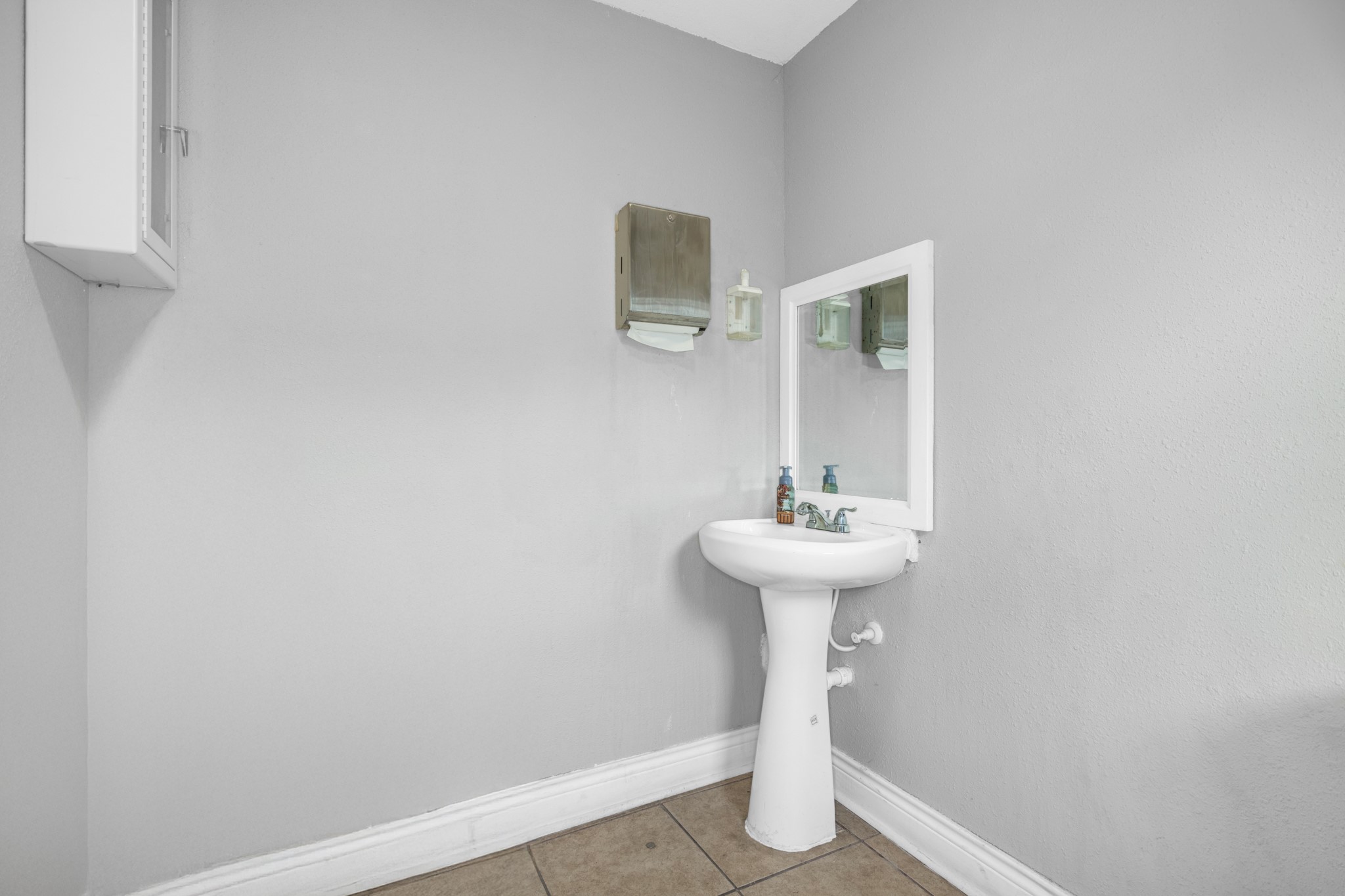 10041 Fulton Street Houston, TX 77076 - Photo 22 of 29 a bathroom with a sink a mirror and toilet