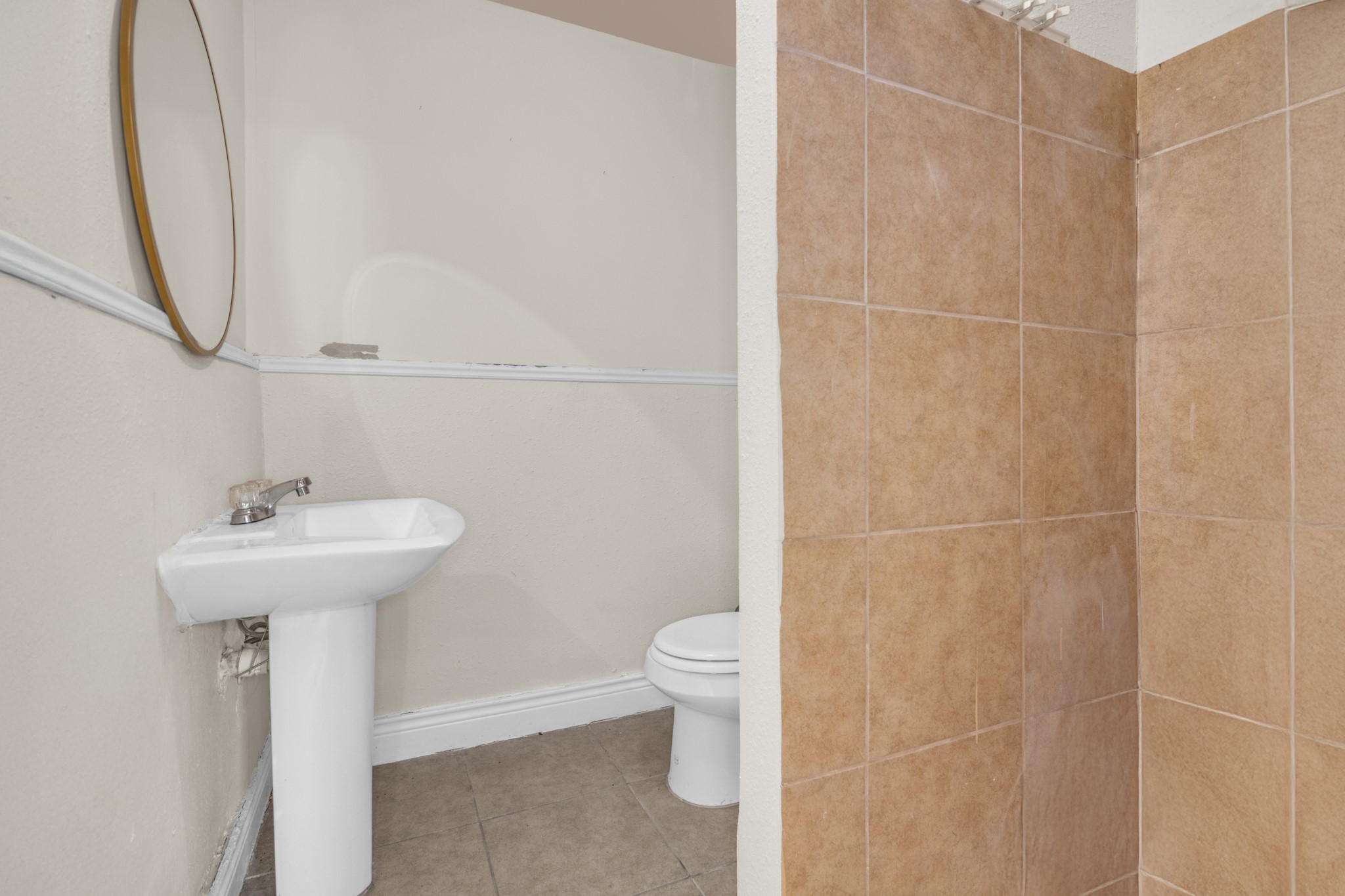 10041 Fulton Street Houston, TX 77076 - Photo 6 of 29 a bathroom with a sink toilet and a mirror