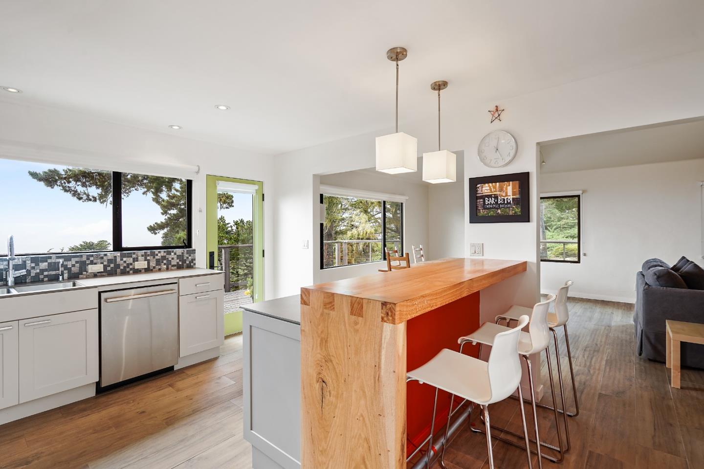 190 Upper Walden Road Carmel, CA 93923 - Photo 11 of 34 a kitchen with stainless steel appliances granite countertop a stove a sink dishwasher and a dining table with garden view