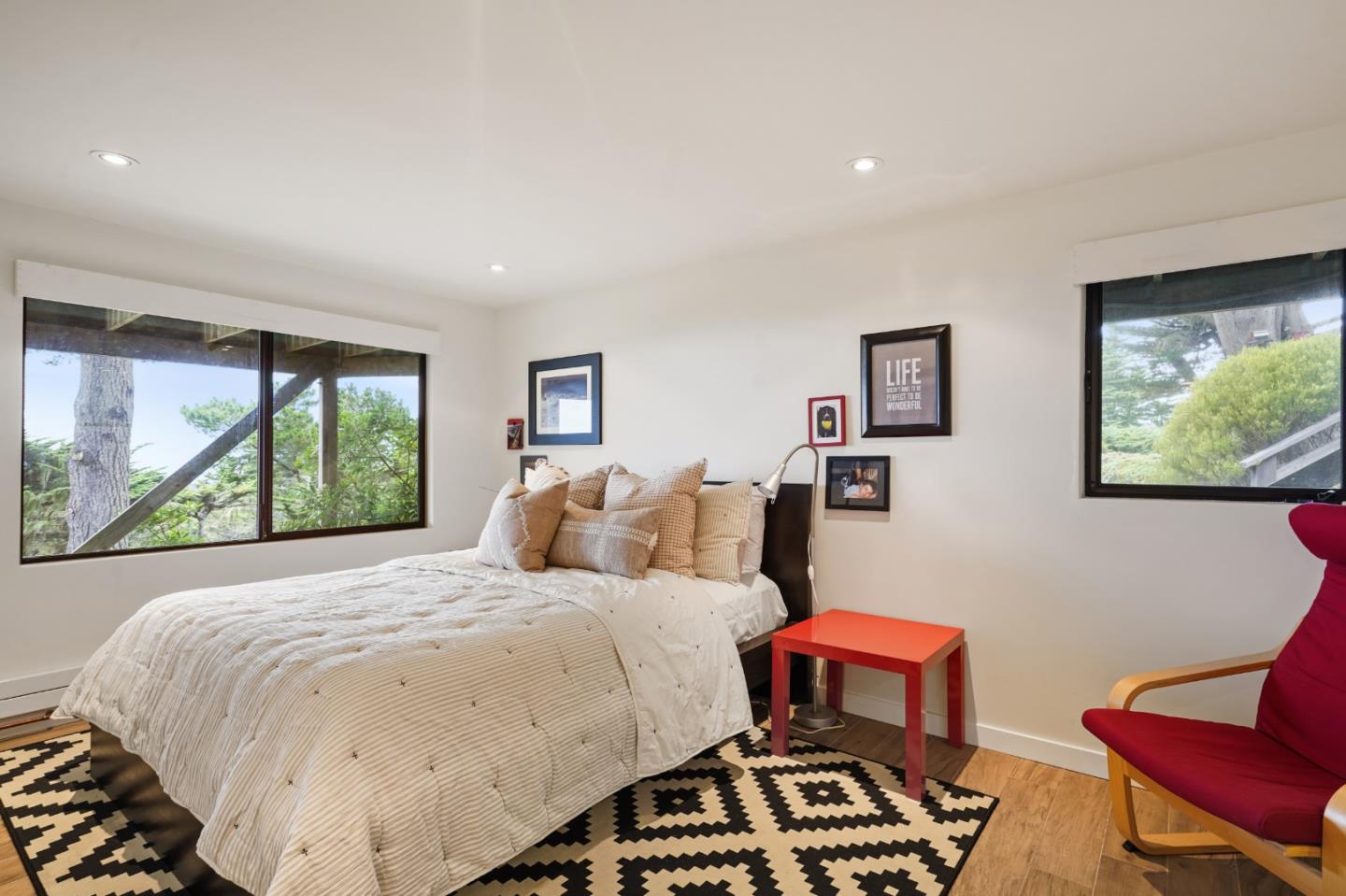 190 Upper Walden Road Carmel, CA 93923 - Photo 22 of 34 a bedroom with a bed two windows and a couch