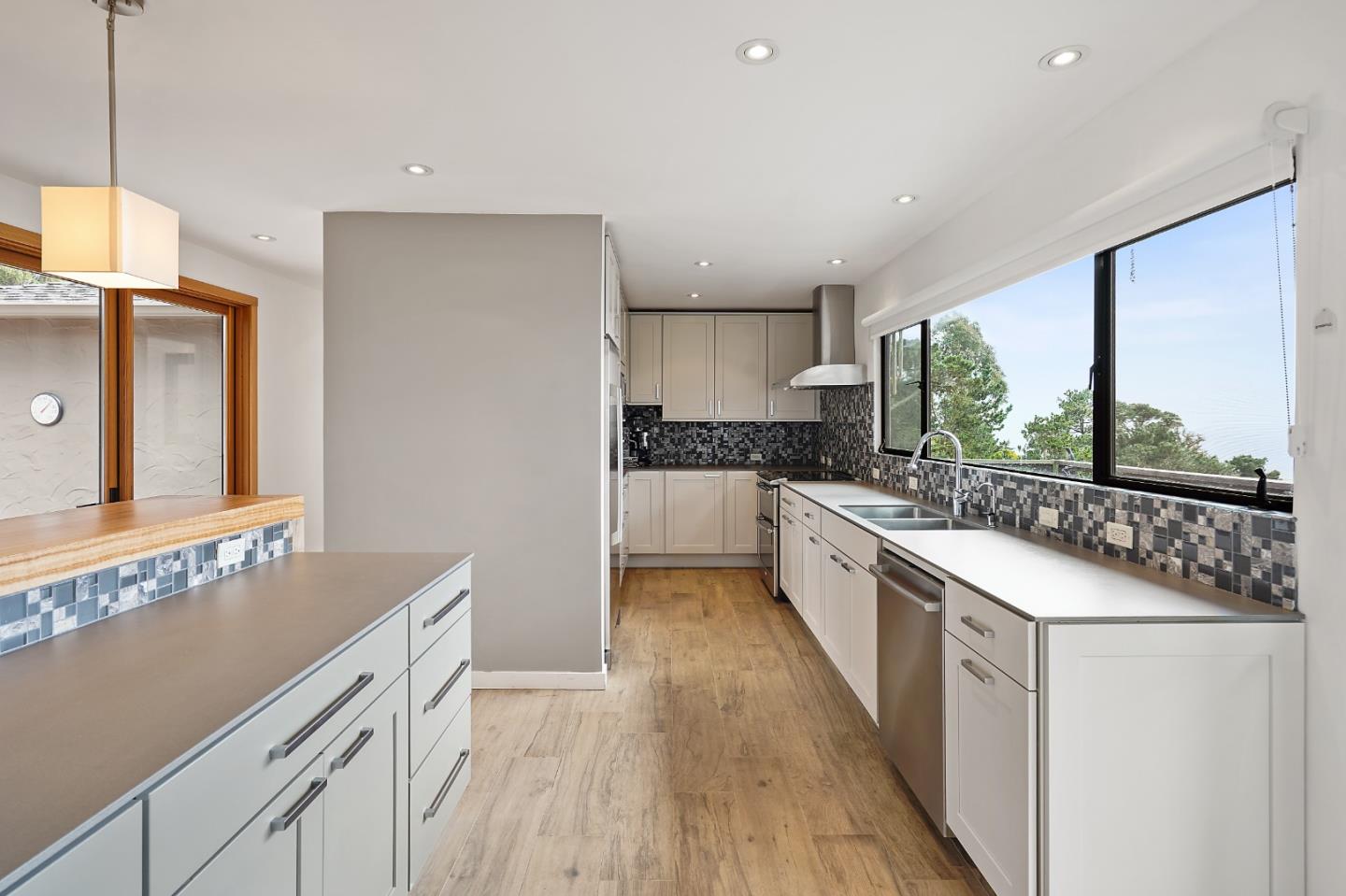 190 Upper Walden Road Carmel, CA 93923 - Photo 8 of 34 a large kitchen with a lot of counter space and wooden floor