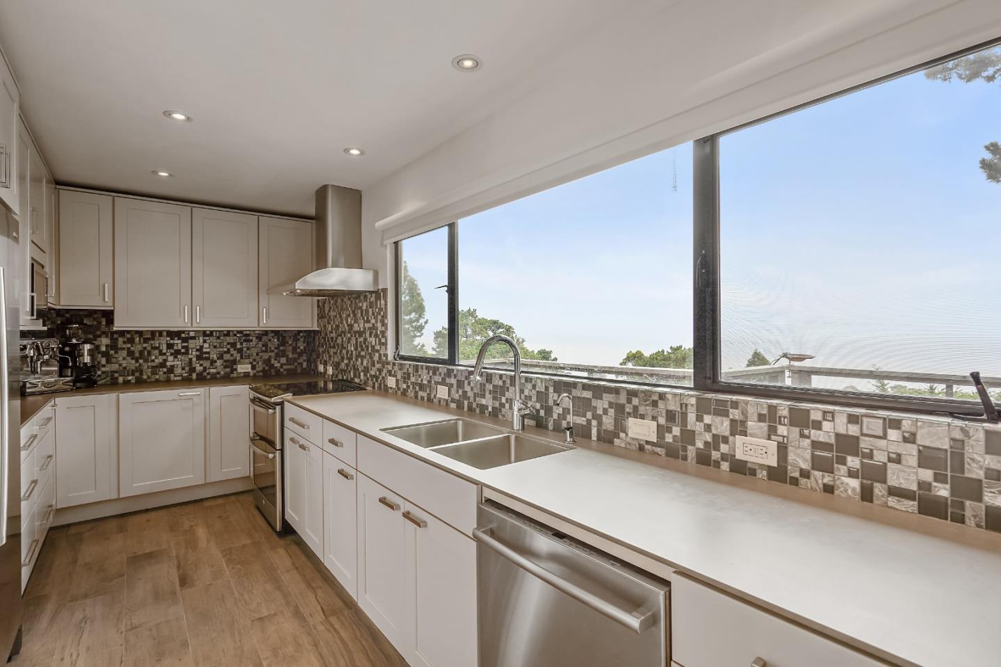190 Upper Walden Road Carmel, CA 93923 - Photo 9 of 34 a kitchen with a sink and white cabinets