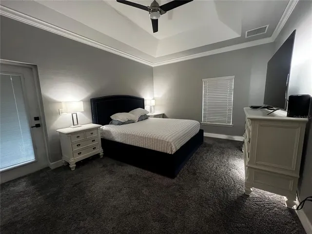 a spacious bedroom with a bed and a couch