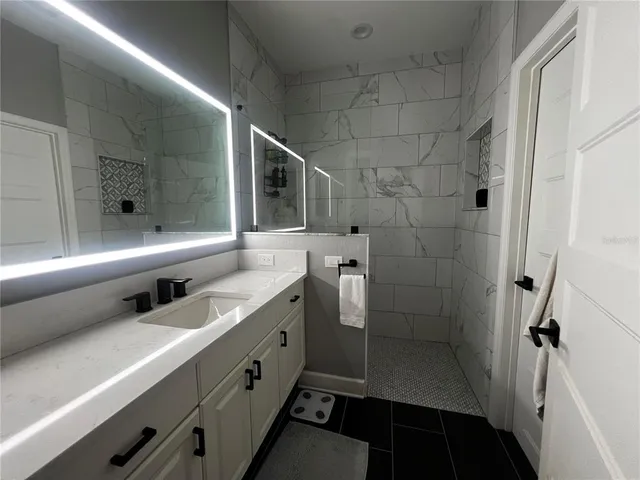 a bathroom with double vanity and a sink