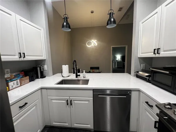 a kitchen with a sink and a refrigerator