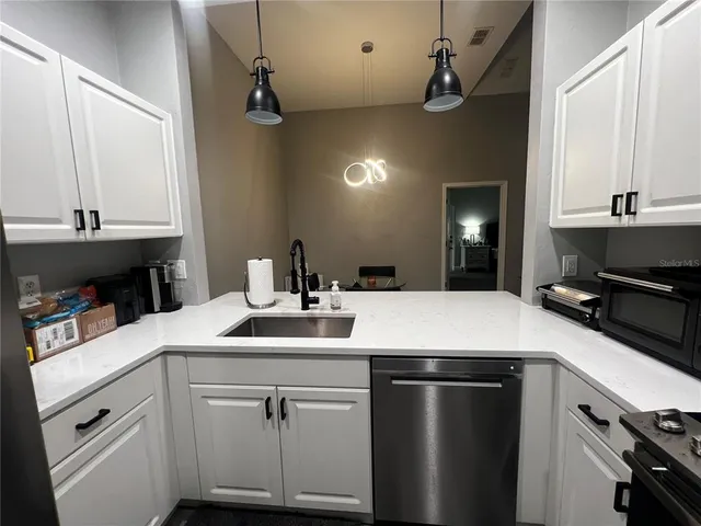 a kitchen with a sink and a refrigerator