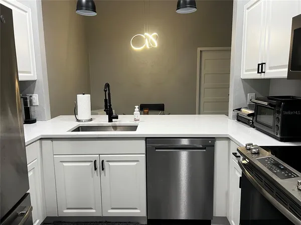 a kitchen with a sink and a stove