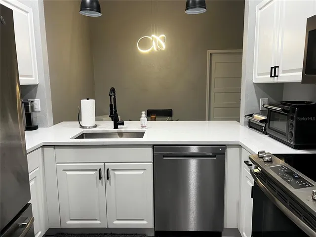 a kitchen with a sink and a stove