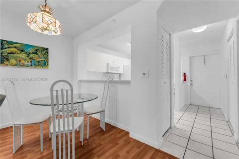 a view of a hallway with wooden floor and a chandelier