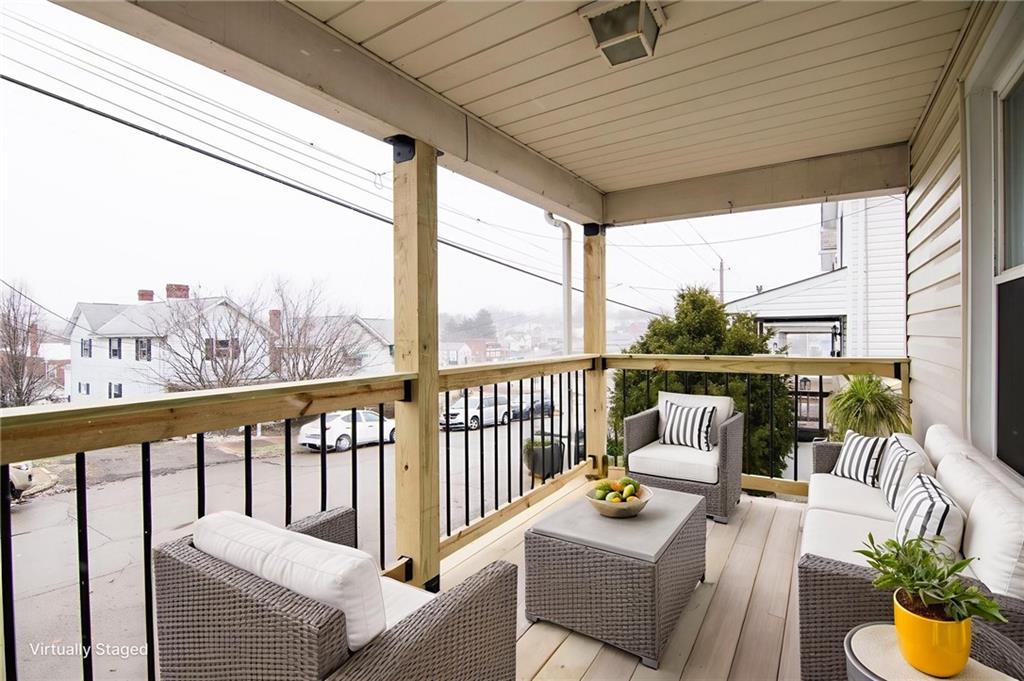 105 Washington Street Mount Pleasant, PA 15666 - Photo 2 of 29 a balcony with furniture and a potted plant